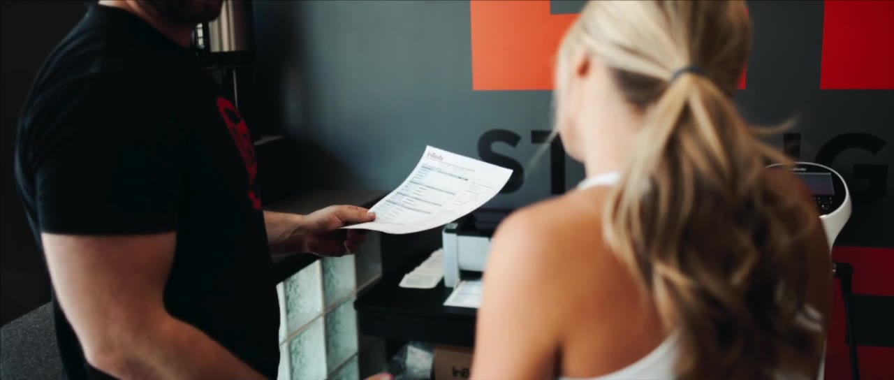 A coach going over body-composition results with a client